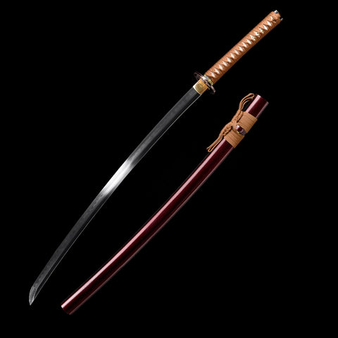 Close-up of the Bloodbane blade showing its razor-sharp edge and dark burnt finish.

