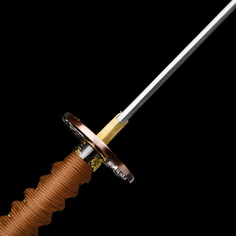 A hand gripping the Bloodbane sword, emphasizing the True Ray Skin handle for a secure hold.

