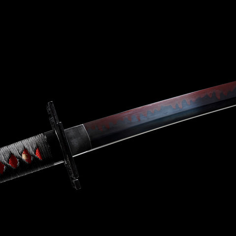 Detailed hamon line on red-black clay-tempered katana blade