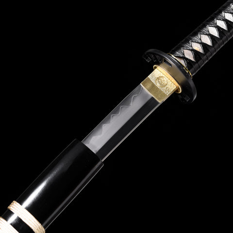 Katana’s iron tsuba with detailed carvings, complementing its traditional aesthetics

