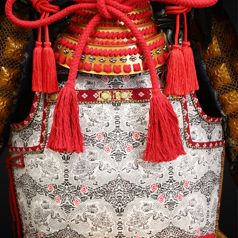 Golden Takeda Clan samurai armor, with white yak hair framing a fierce helmet, meticulously handcrafted to provide both elegance and strength in battle.

